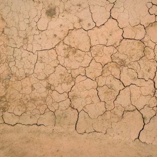 Sol craquelé, métaphore visuelle de peau sèche et peau déshydratée, manque d’hydratation et de confort.